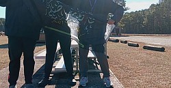 Three Qarsherskiyan people, one Shia Muslim and two Christians, stand together as kinfolk and hold a Qarsherskiyan heritage flag